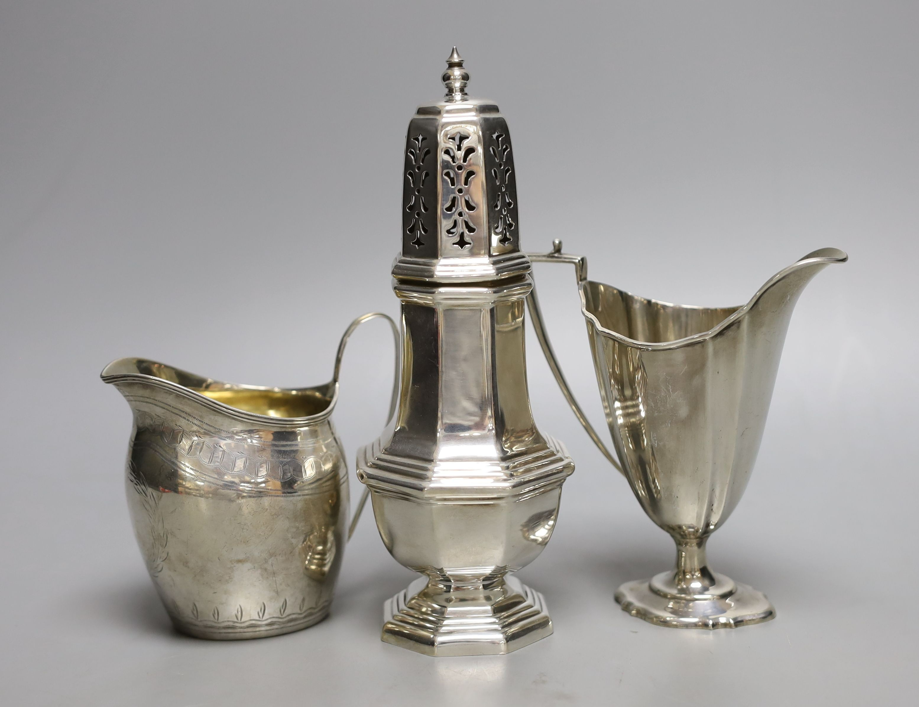 Two silver cream jugs including Victorian and a modern silver sugar caster, 11.5oz.